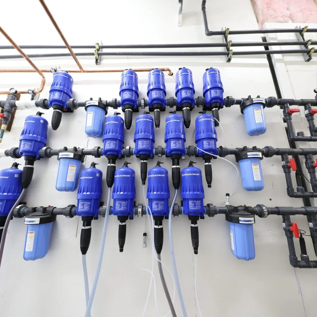 Nutrient dosing and irrigation system for an indoor cultivation facility